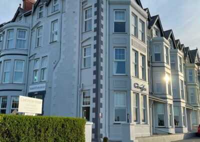 A Victorian building in the early morning sunshine. The name The Caerwylan is on the front.