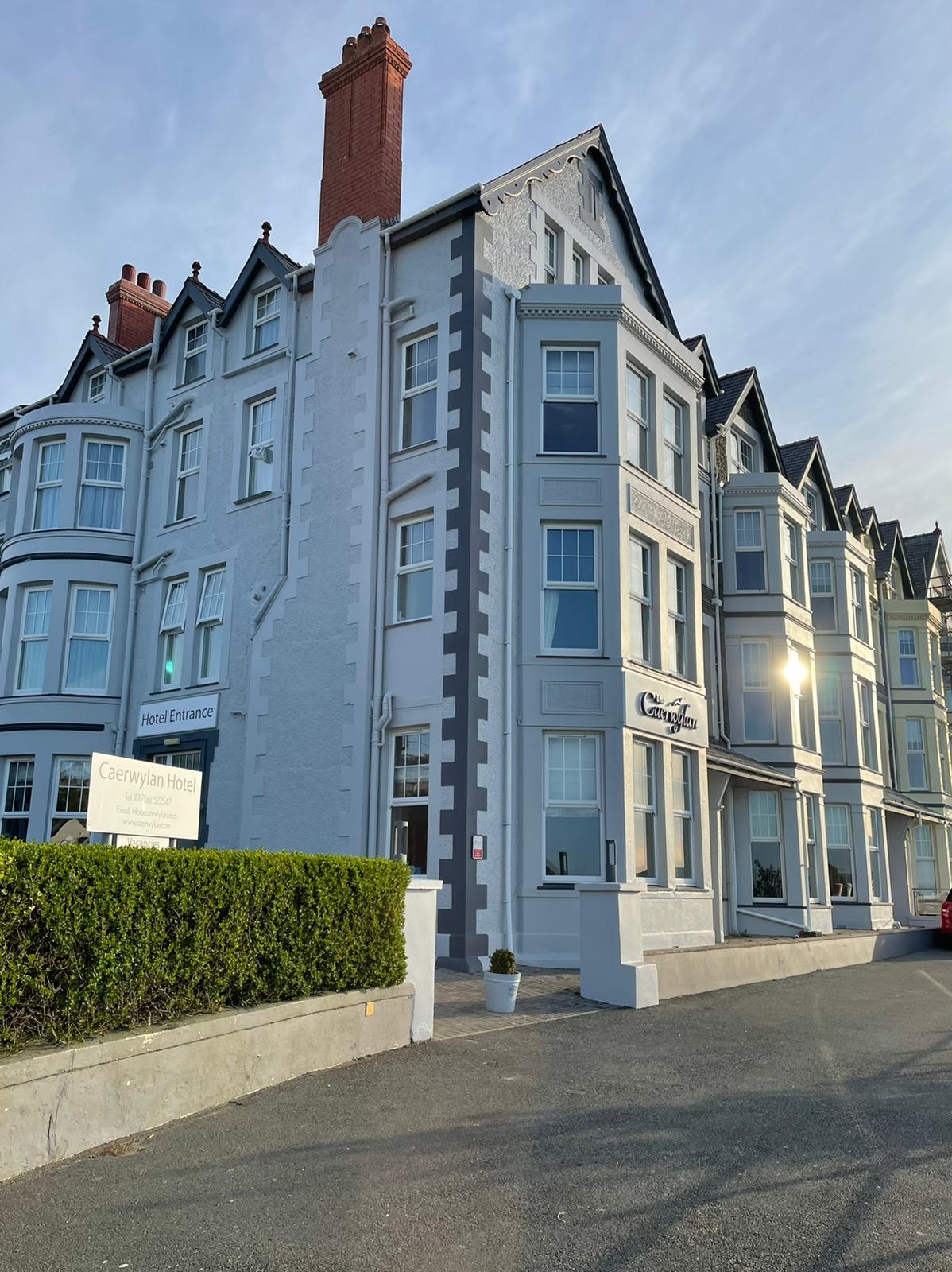 A Victorian building in the early morning sunshine. The name The Caerwylan is on the front.